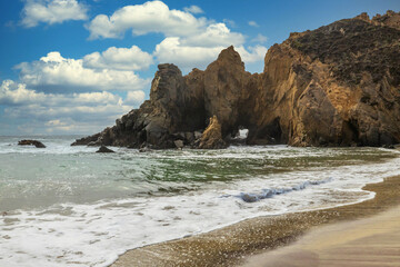 Pfeiffer Beach in Big Sur is an incredibly picturesque beach, beautiful landscape on the Pacific coast, rocks, sand, ocean and sky. Concept, vacation, photo for postcards, tourist and travel guide.