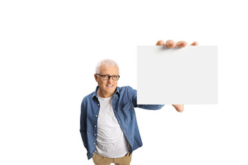 Casual mature man with glasses and white hair holding a blank card in front of camera