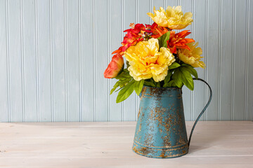 Beautiful silk floral bouquet in antique watering can.