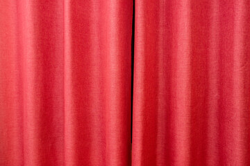 Closed red theater curtain, silk background.