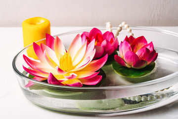 Aromatic bowl with candles and flowers