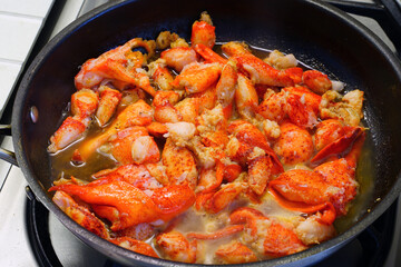 Sauteeing lobster meat in a pan