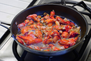 Sauteeing lobster meat in a pan