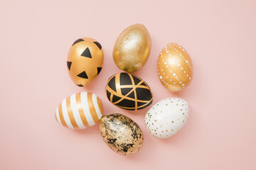 Easter golden decorated eggs on pastel pink background. Minimal easter concept. Happy Easter card with copy space for text. Top view, flatlay
