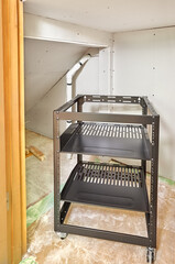 Rolling equipment rack for under stair network closet. Drywall installed. 