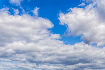 Naklejka na ściany i meble Blue sky with white clouds abstract background or texture.