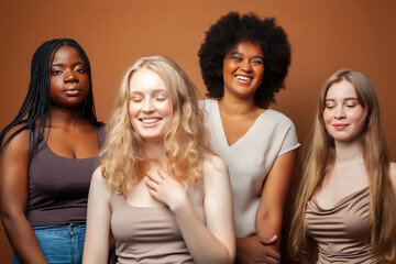 Obraz premium young pretty caucasian, afro, scandinavian woman posing cheerful together on brown background, lifestyle diverse nationality people concept