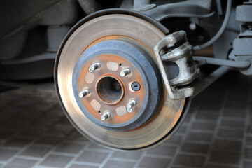 Disk brake and caliper in process of new tire replacement