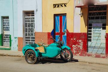 Old motorcycle parking in the old town Havana. The streets of Havana. green motorcycle with a sidecar