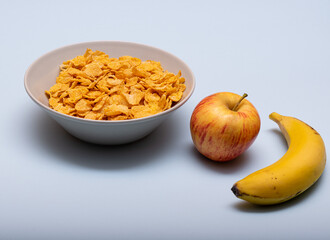 cereals, banana and apple, rich carbs healthy food in a white background