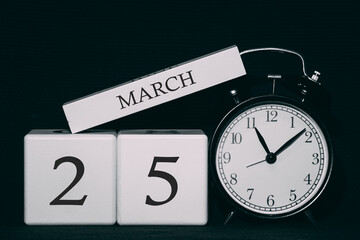 Important date and event on a black and white calendar. Cube date and month, day 25 March. Spring season.