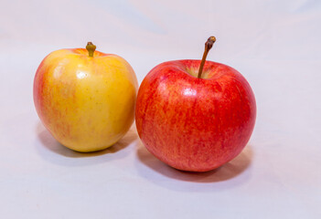 Two red and yellow apples on a white background