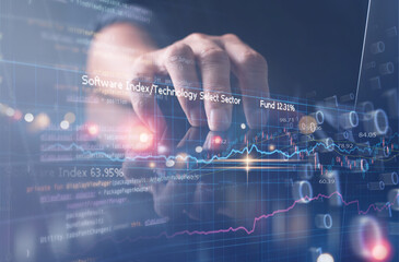 Businessman working on digital tablet and laptop computer with digital diagram and computer code, business and financial technology concept