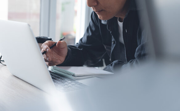 Work from home, telework concept. Man in smart casual wear working on laptop computer, making video call via laptop computer, using zoom online meeting app