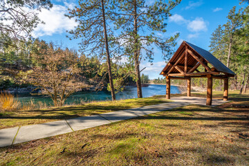 A log gazebo sits in Corbin Park overlooking the Spokane River in Post Falls, Idaho, USA