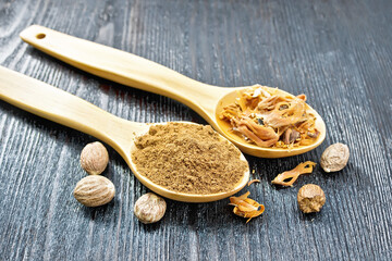 Nutmeg round and mace in spoons on board