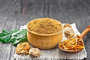 Nutmeg round in bowl and mace in spoon on burlap