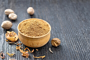 Nutmeg round in bowl on board