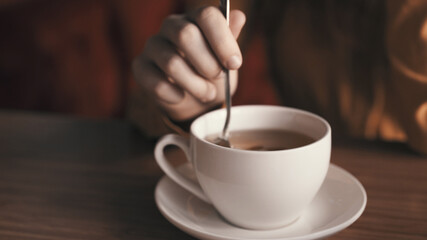 Hot drink in white cup on tea party table rest