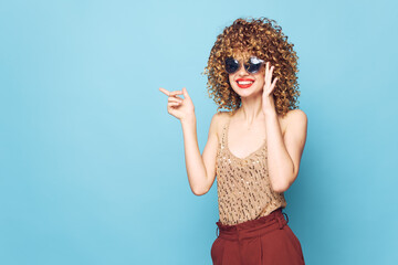 woman fashion Curly hair smile sunglasses blue background 