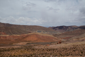 The arid desert.  View of the dry land, valley and colorful mountains under a beautiful sky, high in the Andes mountain range.
