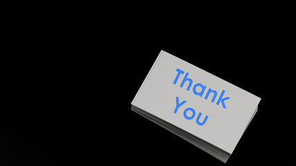 A word Thank You on white paper name card  with black background. Concept for presentation