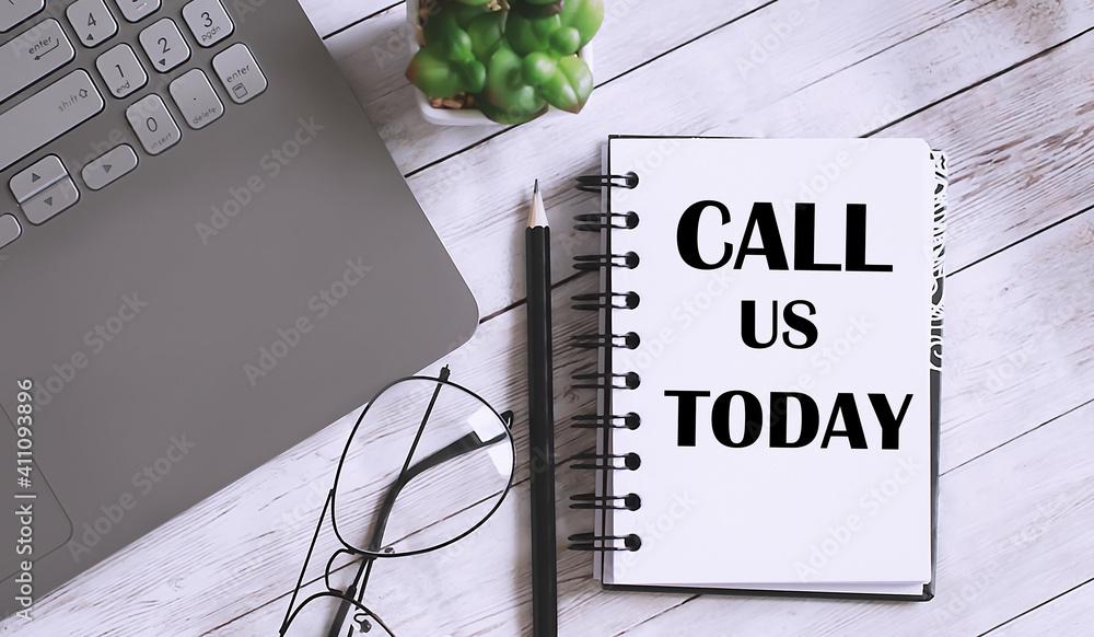 Poster call us today text on the notebook with office background