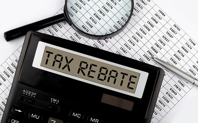 Calculator with text TAX REBATE on the chart. Business, finance conceptual.
