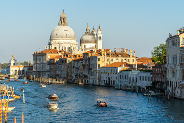 Fototapeta na wymiar Beautiful Venetian cityscape at sunset, with a view on the Grand Canal and the domes of Santa Maria della Salute, Venice, Italy