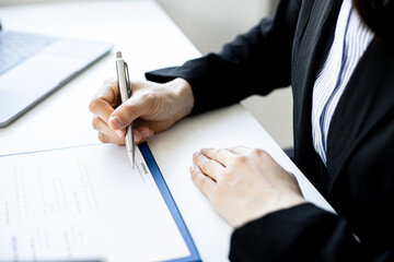Close-up of a Businesswoman about to sign a real estate lease document, signing an important document contract. Real estate trading ideas.