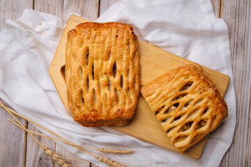 Top view on fresh baked apple and nuts pie on the wooden cutting board