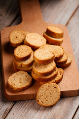 Closeup on pile of dried bread crackers on the wooden background