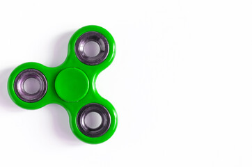 Plastic bright green spinner on white background close-up of kopi space