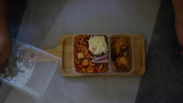 Open set of macaroni in takeaway plastic lunch box 