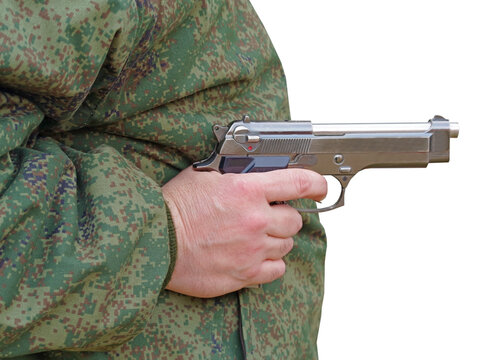 a gun in the hand of a military man