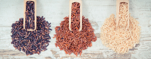 Vintage photo, Brown, black and red rice on scoops, healthy, gluten free nutrition concept