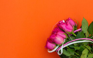 Bouquet of pink roses on bright orange background. Top view. Space for text. - 411111481