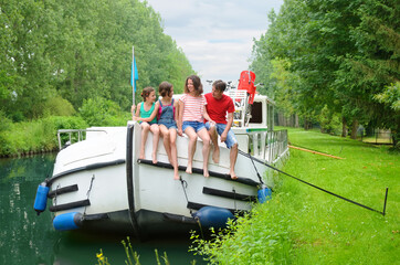 Family vacation, summer holiday travel on barge boat in canal, happy kids and parents having fun on river cruise trip in houseboat in France
 - obrazy, fototapety, plakaty