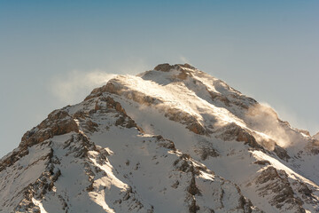 Snowy mountain peak on winter day