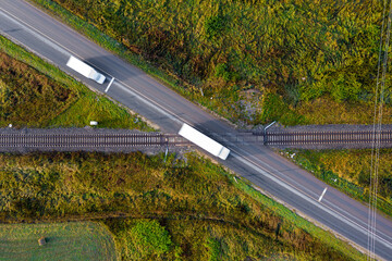 aerial top down view on railroad crossing with asphalt road