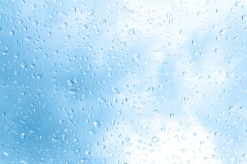 Naklejka na ściany i meble Water drops or Rain drops on glass with blue filter