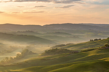 Naklejka na ściany i meble Dawn in a Rural rolling landscape with fog