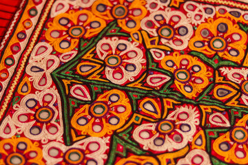Mirrored embroidery work typical of the Aahir tribe,unidentified man embroidering cloth in traditional method of India,mirror work colorful handmade ahir bharat,Kutch-gujarat