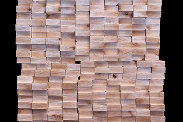 Large stack of new boards of natural solid birch for table legs production on black background