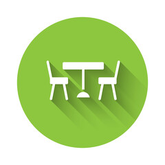 White Picnic table with chairs on either side of the table icon isolated with long shadow. Green circle button. Vector.