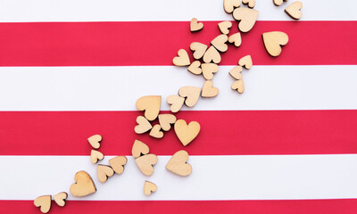 Copy space background with wooden hearts on red white striped background. valentine day greeting card