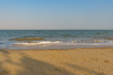 Fototapeta na wymiar Empty beach against blue clear sky