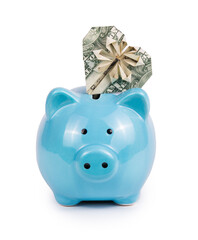 Blue piggy bank and dollar heart. Origami heart from banknote