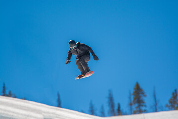 snowboarder pulling tricks on the Colorado Rockies slopes