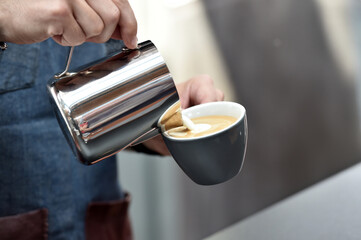 Detail of hand, glass and freshly roasted coffee.